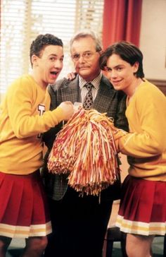 three people standing next to each other with cheerleaders