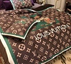 a bed with louis vuitton blankets and pillows