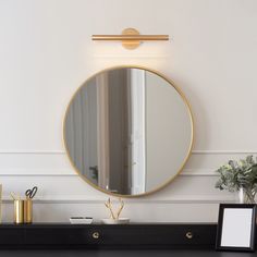 a mirror on the wall above a dresser