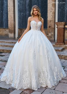 a woman in a white wedding dress standing outside