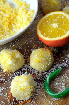 oranges, sugar and other ingredients on a cutting board next to an orange slice