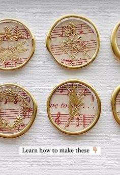 four gold buttons with music notes and leaves on them, all in different shapes and sizes