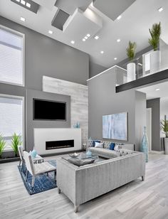 a modern living room with gray walls and white furniture, large windows on the ceiling