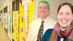 two people standing next to each other in a hallway