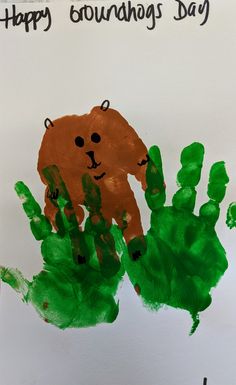 a hand print with the words happy groundhog's day on it and a brown bear