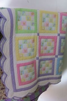 a baby quilt is hanging on the wall