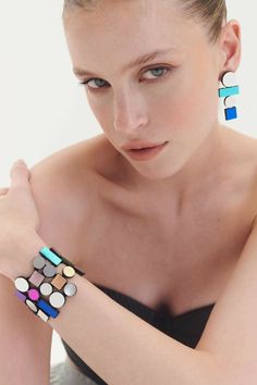 Elevate your wristwear with our Bauhaus Collection Bracelet, a reflection of 20th-century design, art, and architectural movements. Inspired by craftsmanship, modernism, and spatial exploration, this bracelet seamlessly integrates with the vibrant hues of our Rainbow Collection, infusing your days with a burst of colors. 🌈 Effortless Chic Design: Indulge in the comfort of our Bauhaus Collection Bracelet, featuring a chic design crafted with precision and attention to detail. The snap button closure adds a touch of ease and style. 🔍 Material Excellence: Fashioned from a fusion of leather and acrylic, this bracelet is chic and lightweight. 🎁 Inclusive Packaging: Your statement bracelet arrives in exquisite gift packaging, presented in a fabric-lined folio that protects the jewelry finish. Modern Multicolor Jubilee Bracelets, Modern Multicolor Geometric Jewelry, Modern Geometric Blue Jewelry, Modern Blue Geometric Jewelry, Modern Adjustable Geometric Jewelry, Architecture Movement, Engagement Icon, Wedding Ring Icon, Workshop Icon