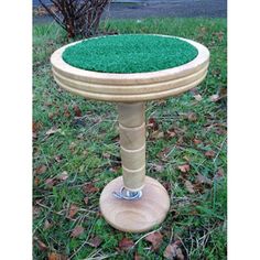 a wooden stand with green grass on it