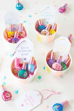 three small boxes filled with different types of items on a table next to confetti