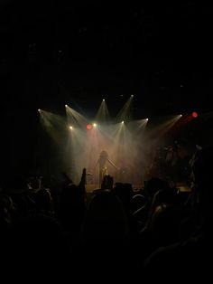 a concert scene with the lights on and people in the audience looking at them as they perform