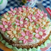 there is a cake that has been decorated with pink, green and yellow candy hearts