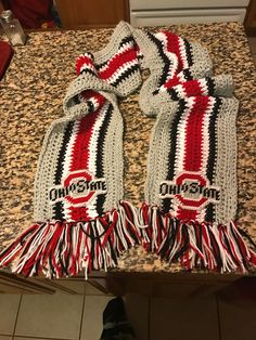 two scarfs sitting on top of a kitchen counter