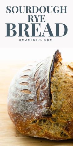 a loaf of sourdough rye bread sitting on top of a wooden table