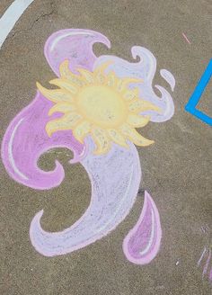 a chalk drawing of a sun on the ground