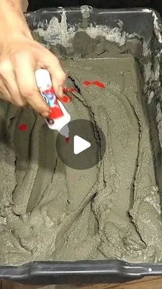 a person is using a spatula to paint the inside of a cake pan with green icing