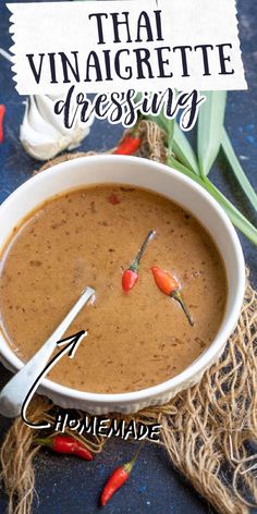 the ingredients for thai vinaigrete dressing in a white bowl on a blue surface