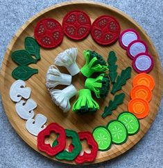 a wooden plate topped with cut up vegetables