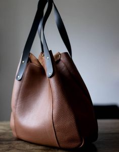 "Big leather tote bag in the padded medium brown leather, with black straps. This bag can be carried like a tote and over the bucket bag. The bag is close with two magnetic snaps. Hardware in old gold colour. Inside without lining. If You want some changes please feel free to write to me. Measurements: Width: 18\"- at the top, the flat, 14,5\"- down Height: 13\"- in the middle, 15\"- the side shoulder straps- 20,5\" Standard delivery time: European union: 4 - 10 days Europe (not EU): 7 - 14 days Boho Leather Purse, Leather Fringe Bag, Brown Leather Tote Bag, Brown Tote Bag, Brown Leather Totes, Brown Tote, Leather Shoulder Handbags, Brown Leather Bag, Boho Leather