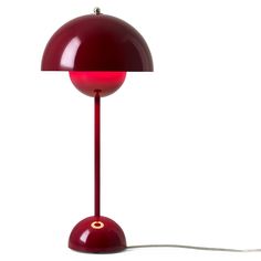 a red table lamp on a white background