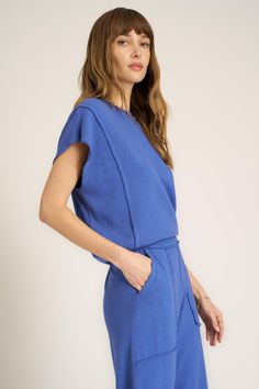 The perfect top doesn't exi--Our Mystic Terry Top is truly the best of both worlds when it comes to comfort and style. It starts with a soft terry fabric, crew neckline, and an overall relaxed silhouette. Little details like cap sleeves, exposed seams, and a contrast rib hemline finish it off. The best part? There's a matching pant, too. 63% Cotton37% Rayon Care Instructions: Machine wash cold. Wash inside out with similar colors. Do not bleach. Lay flat to dry. Cool iron if needed. Measurements Blue Crew Neck Comfortable Tops, Comfortable Blue Crew Neck Tops, Relaxed Blue Crew Neck Top, Sporty Washed Blue Relaxed Fit Top, Blue French Terry Crew Top, Blue Relaxed Fit Knit Top, Blue Relaxed Fit Soft-washed Top, Soft-washed Relaxed Fit French Terry Tops, Exposed Seams