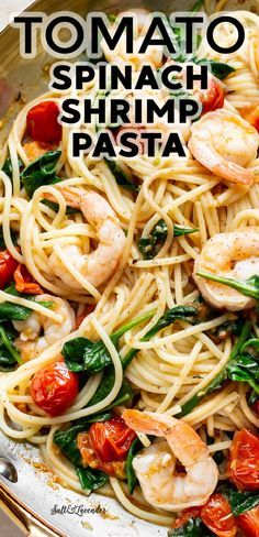 pasta with shrimp, spinach and tomatoes in a skillet