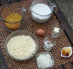 ingredients to make macaroni and cheese on a mat