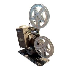 an old movie projector sitting on top of a metal stand with wheels attached to it