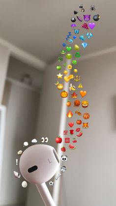 a mobile phone hanging from the ceiling with lots of colorful objects coming out of it