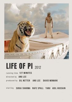 a man standing next to a tiger on top of a boat