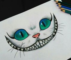 a drawing of a smiling cat's face with blue eyes and fangs on it