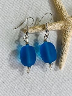 Blue Cultured sea glass silver plated wire earrings with silver plated beads. The silver plated earring hooks and wire are tarnish resistant. The earring hooks are nickel free. These are a great gift for someone special! Made in Hawaii. Blue Sterling Silver Earrings With French Hook, Sterling Silver Blue French Hook Earrings, Beach Earrings With Recycled Glass And Ear Wire, Blue Sea Glass Nickel Free Earrings, Blue Sea Glass Nickel-free Earrings, Handmade Blue Sea Glass Earrings, Nickel-free Blue Sea Glass Earrings, Blue Recycled Glass Dangle Earrings, Silver Hypoallergenic Sea Glass Earrings