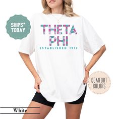 a woman wearing a white t - shirt that says, thea phi established 1917