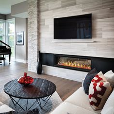 a living room with a piano and fireplace