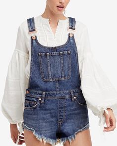 Your easiest (and edgiest) warm-weather classic. Cut-off style overalls with cool utility details, bib front, criss-cross back, metal grommets and a raw hem. The perfect addition to your closet. More distressed denim? Yes, please! Unlined. Imported. 100% Cotton Machine wash cold w/ like colors and non-chlorine bleach Tumble dry low, low iron, may be dry cleaned NEED A SIZE? LET US KNOW! 24 25 26 27 waist 30" 32" 34" 36" hip 32" 34" 36" 38" length 28" 28" 28" 28" inseam 3" 3" 3" 3" Overall Shorts Outfit, Shorts Outfit Ideas, Overalls Outfits, Denim Short Overalls, Shorts Overalls, Oversized Long Sleeve Shirt, 2018 Style, Free People Summer, Style Overalls