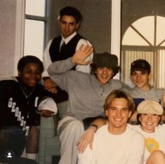 a group of young men sitting next to each other