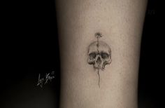 a small skull tattoo on the ankle