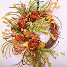 an arrangement of flowers and leaves on a white background with the letter o in the center