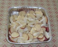 a pan filled with sliced apples on top of a table