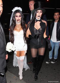 two women dressed in costumes walking down the street