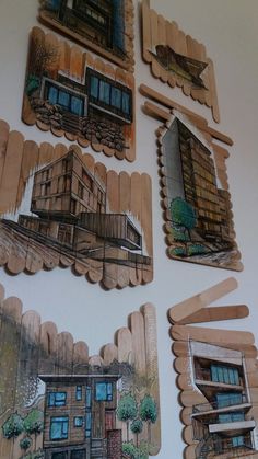 four pieces of wood cut out to look like houses and buildings with windows on them