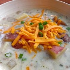 a white bowl filled with soup and cheese