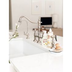 a white sink sitting under a faucet next to a counter top in a kitchen