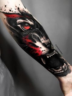 a man's arm with a black and red tiger tattoo on the left forearm