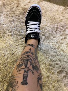 a person's foot with tattoos on it