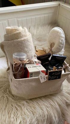 a basket filled with items sitting on top of a white fur covered floor next to a window