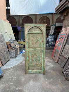 an old wooden door sitting in the middle of a room