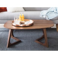 a coffee table with drinks on it in front of a couch