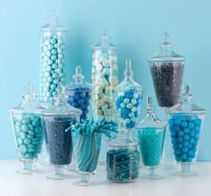 there are many different types of candies in glass containers