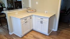 a kitchen with white cabinets and an island