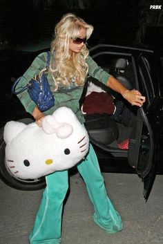 a woman in hello kitty costume getting out of her car